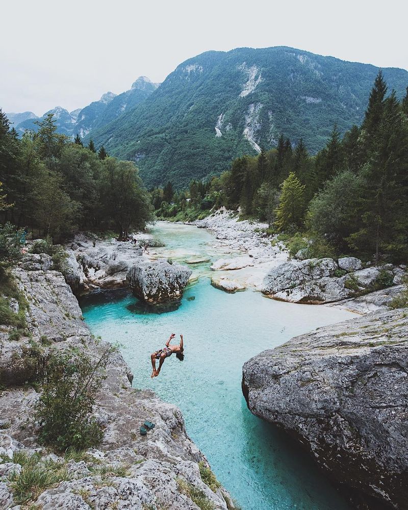 image: The Soča that flows through Triglav National Park in Slovenia has to be one of the clearest and purest rivers I've ever seen. Even on a rainy day the colors would blow your mind! Thanks Shane for the epic backflip :) #peaksofeurope by lebackpacker