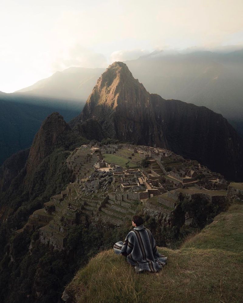 image: I've seen pictures of Machu Picchu but could never have imagined that I would see it with my own eyes. As the sun set below the surrounding mountains these light beams illuminated the smoke from distant fires and lit up the sky. Very fortunate to have... by josiahwg