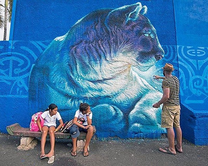 image: Kalouf @kaloufart finishing up a section of a long schoolyard wall painted with @marko93darkvapor for @onoutahiti #onou2016 #streetart #tahiti #catsofinstagram #catstagram by marthacoop